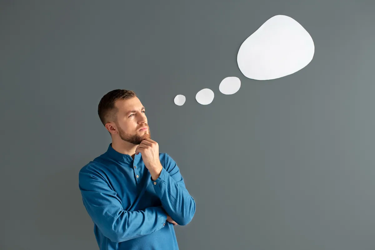 Man deep in thought with thought bubbles above his head, representing the concept of testing advice and making informed decisions