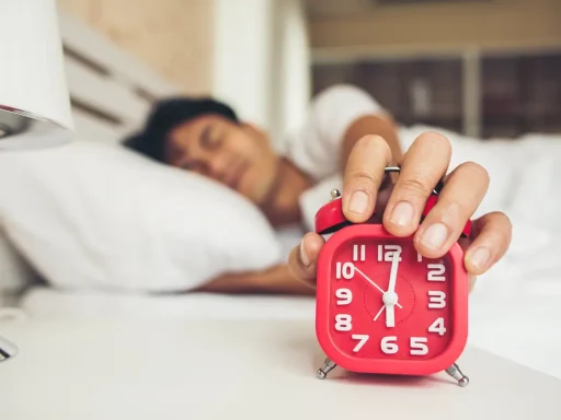 Man waking up to an alarm clock, representing overcoming laziness