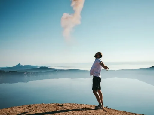Person standing on a mountain top, feeling free and overcoming negative feelings